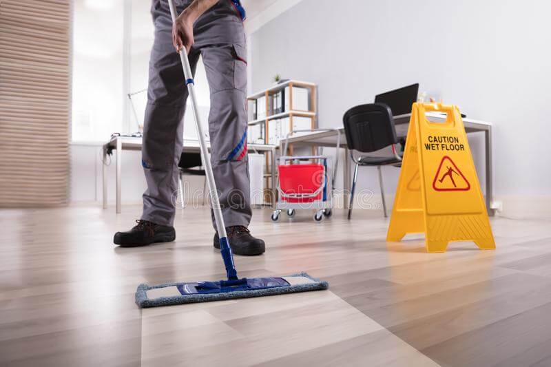 cleaning-floor-office-low-section-male-janitor-cleaning-floor-caution-wet-floor-sign-office
